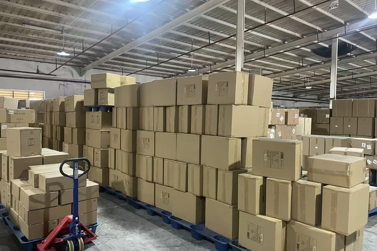 Pallet jack and stacked export cartons in XCJD warehouse